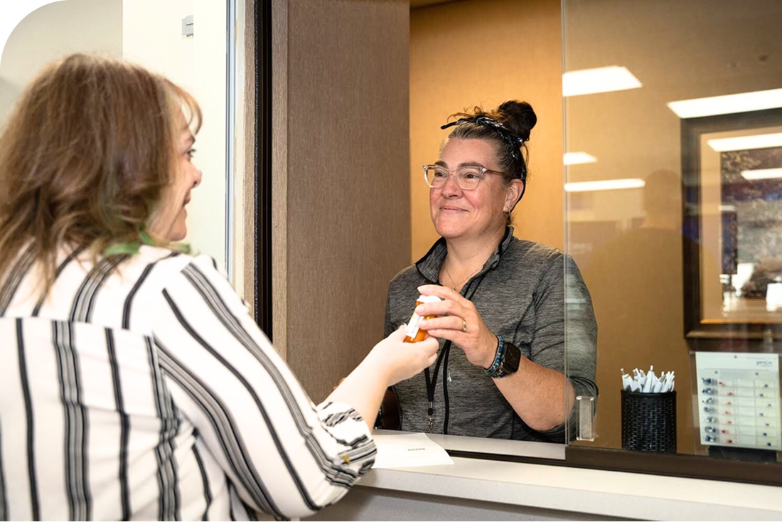 Genoa pharmacy team member talking with a customer at the mental health clinic.